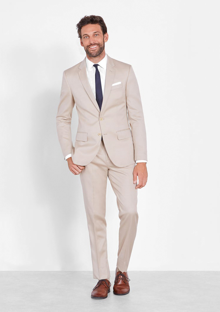 Beige suit, white dress shirt, navy tie, and brown derby dress shoes